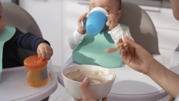 Woman Patiently Feeding Puree to Baby