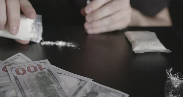 Young Addicted Man Taking Cocaine with Dollar