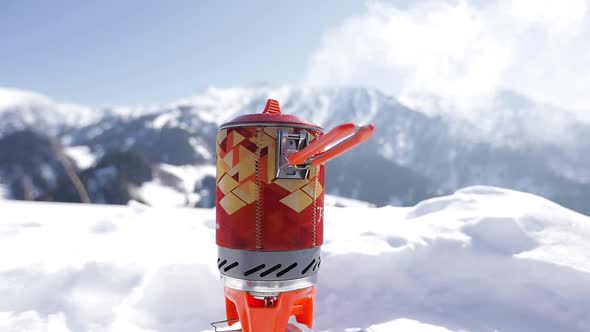 Pot with Boiling Water at Gas Stove in the Mountains