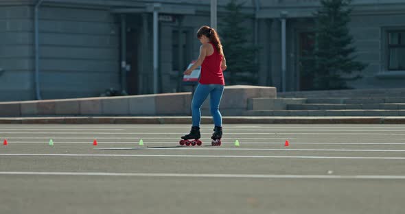 Girl Teenager Dances on Roller Skates Slalom Crisscross