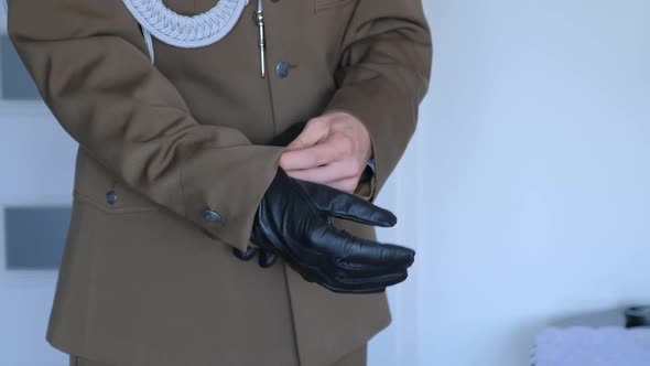 Military Groom Is Putting on Leather Gloves.