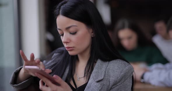 Internet Addiction Woman Uses Phone in Cafe