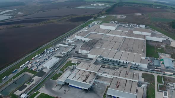 Modern plant on field. Large industrial zone surrounded by nature. 