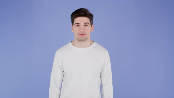 Portrait of Serious Handsome Man in White Longsleeve Looking to Camera