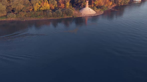 Revealing aerial drone footage of the lighthouse on the side of the Danube river. Autumn colors in n