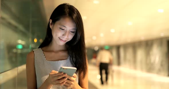 Woman using cellphone and walking in the city 