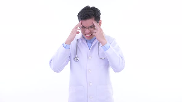 Stressed Young Asian Man Doctor Having Headache