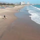 A man runs with a dog, pacific ocean coast beach (Coquimbo, Chile) aerial view - VideoHive Item for Sale