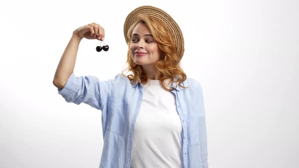 Cheerful Girl in Straw Summer Hat Enjoy the Smell of Fresh Ripe Sweet Cherry Berry Organic Food