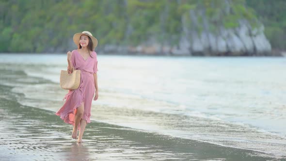 Asian woman enjoy around beautiful beach sea ocean