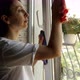 Portrait of Young Woman is Cleaning the Door Window to the Balcony - VideoHive Item for Sale