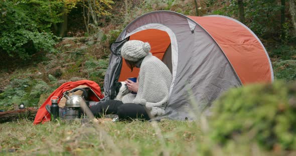 Woman with dog in tent