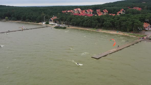 AERIAL: Group of Surfers Uses Power Kites to Slide on the Surface of the Water