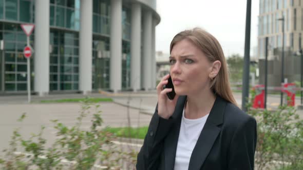 Businesswoman Getting Angry on Phone Call While Walking on the Street