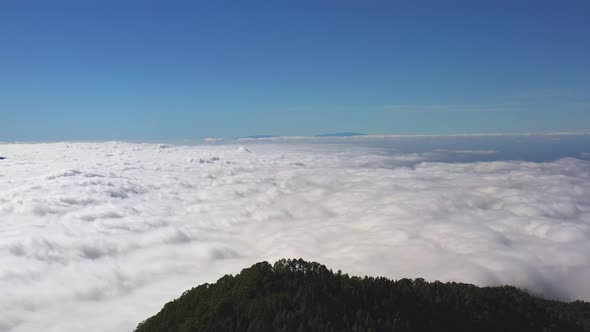 Aerial shot of a majestic view from the Pico de Teide on Canary Islands of a cloud inversion below t