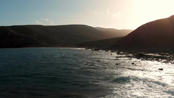 Drone Flying over the ocean coast of Jacomar at the sunset - Fuerteventura