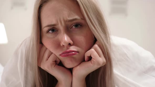 Sad Young Woman Face Close Up in Bed