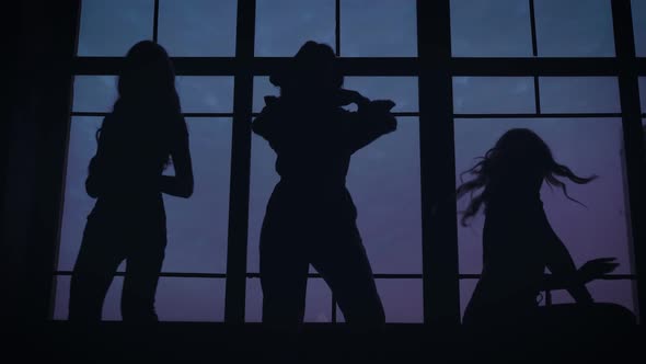 Shooting a Music Video for a Women's Band. Slender Girls Dance Against the Backdrop of a Panoramic