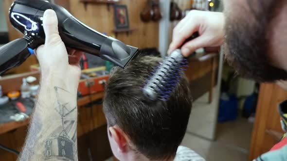 Man hair drying in barber shop