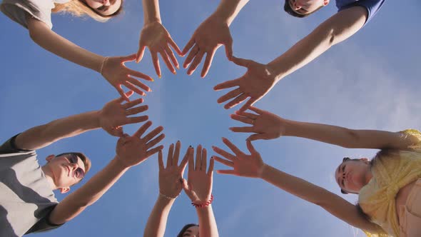 Friends Make a Circle Shape From the Palms of Their Hands