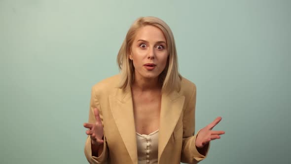 Emotional woman in jacket on blue background