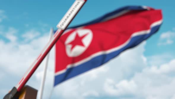 Closed Boom Gate with QUARANTINE Sign at Flag of North Korea