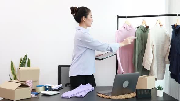 Asian woman selling clothes online