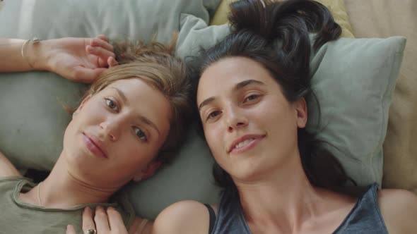 Portrait of Happy Lesbian Couple on Bed