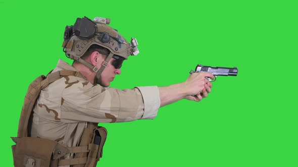 Soldier Aiming and Shooting with a Pistol on a Green Screen, Chroma Key.