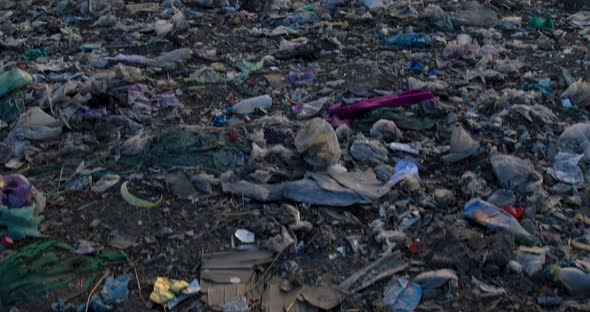 Closeup of burning garbage pile in trash landfill