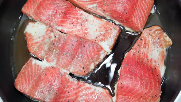 Salmon Fillet is Fried in a Pan Top View