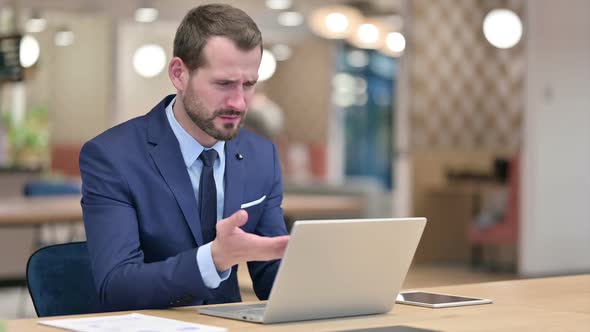 Loss Businessman Reacting to Failure on Laptop in Office