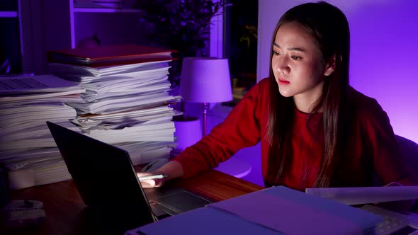 Workaholic people concept. Asian woman drinking coffee during overtime at home office