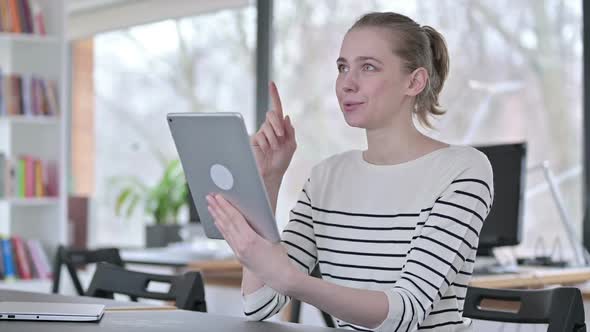 Online Video Chat on Tablet By Young Woman in Library