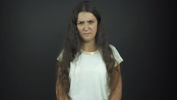 Serious Lady in T-shirt Poses for Photo Shoot in Studio