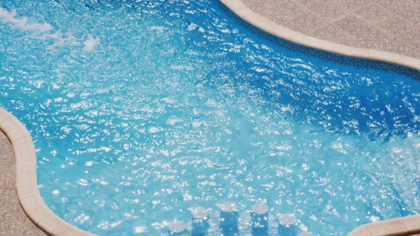 Water Surface On Swimming Pool In Sunny Day