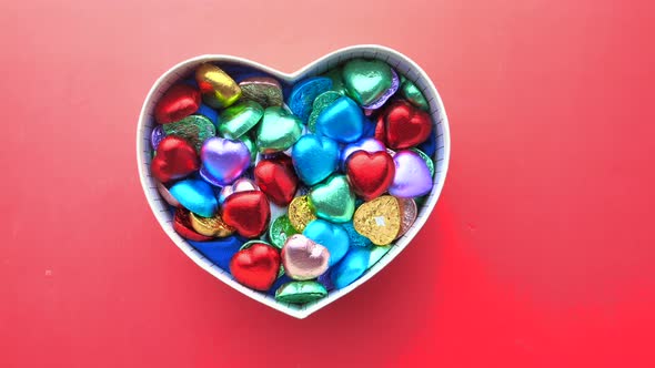  Small Heart Shape Gift with Candy on Red Background 