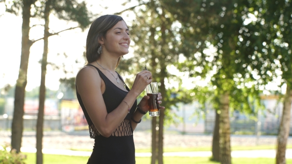 Girl Drinking Cola In Park