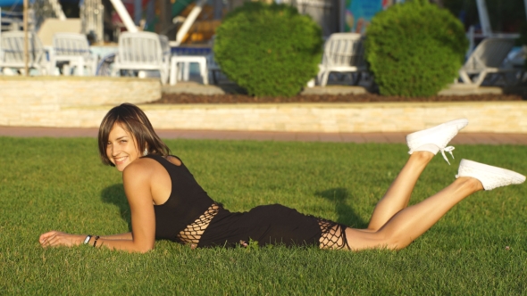 Beautiful Girl Lying On Grass And Laughing