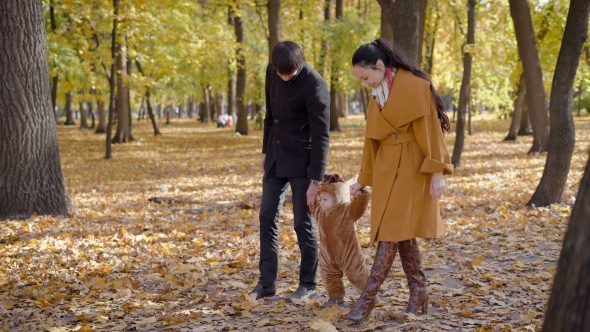 Young Family Spend Their Leisure Time In The Woods.