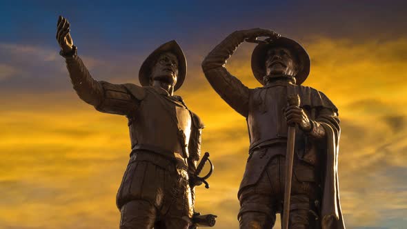 Large zoom in to Francisco de Montejo monument in Merida, Mexico with a sunset yellow sky time lapse