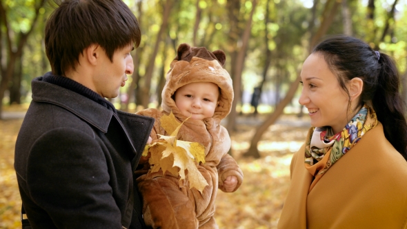 Playful Baby With Parents In The Forest.