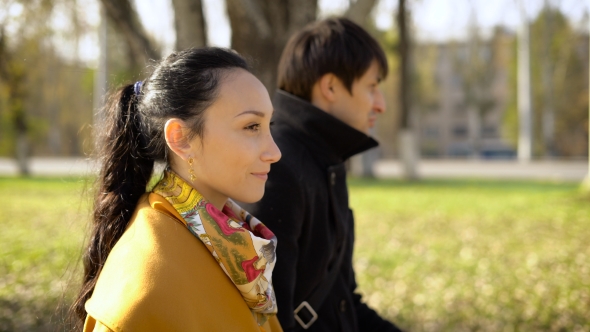 Young Couple Walking On The Alley.