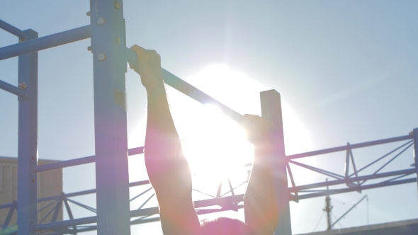 Pulling Up On The Bar, Man Doing Push-ups On The Horizontal Bar