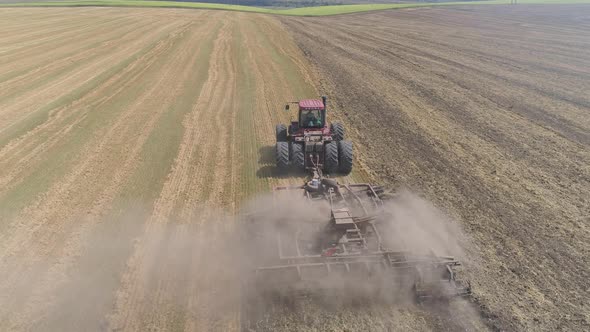 Aerial view of a tractor plowing in the fields