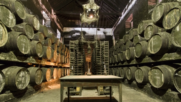 Barrels In The Wine Cellar With Table And Candle On It, Portugal