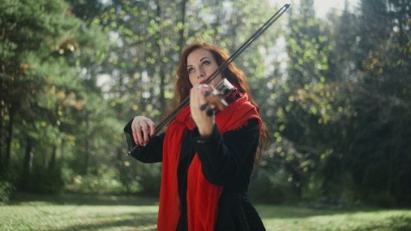 A Musician With a Bright Appearance. Playing The Violin.