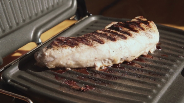 Large Piece of Meat Frying on Electric Grill