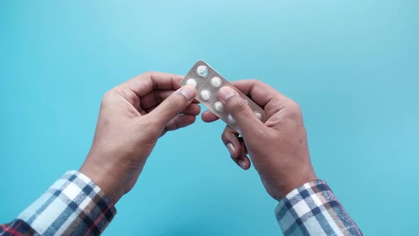 Close Up of Person Hand Taking Medicine From a Blister Pack