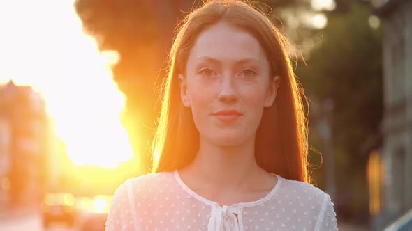 Beautiful Ginger Woman is Opening Her Blue Eyes While Looking at Camera